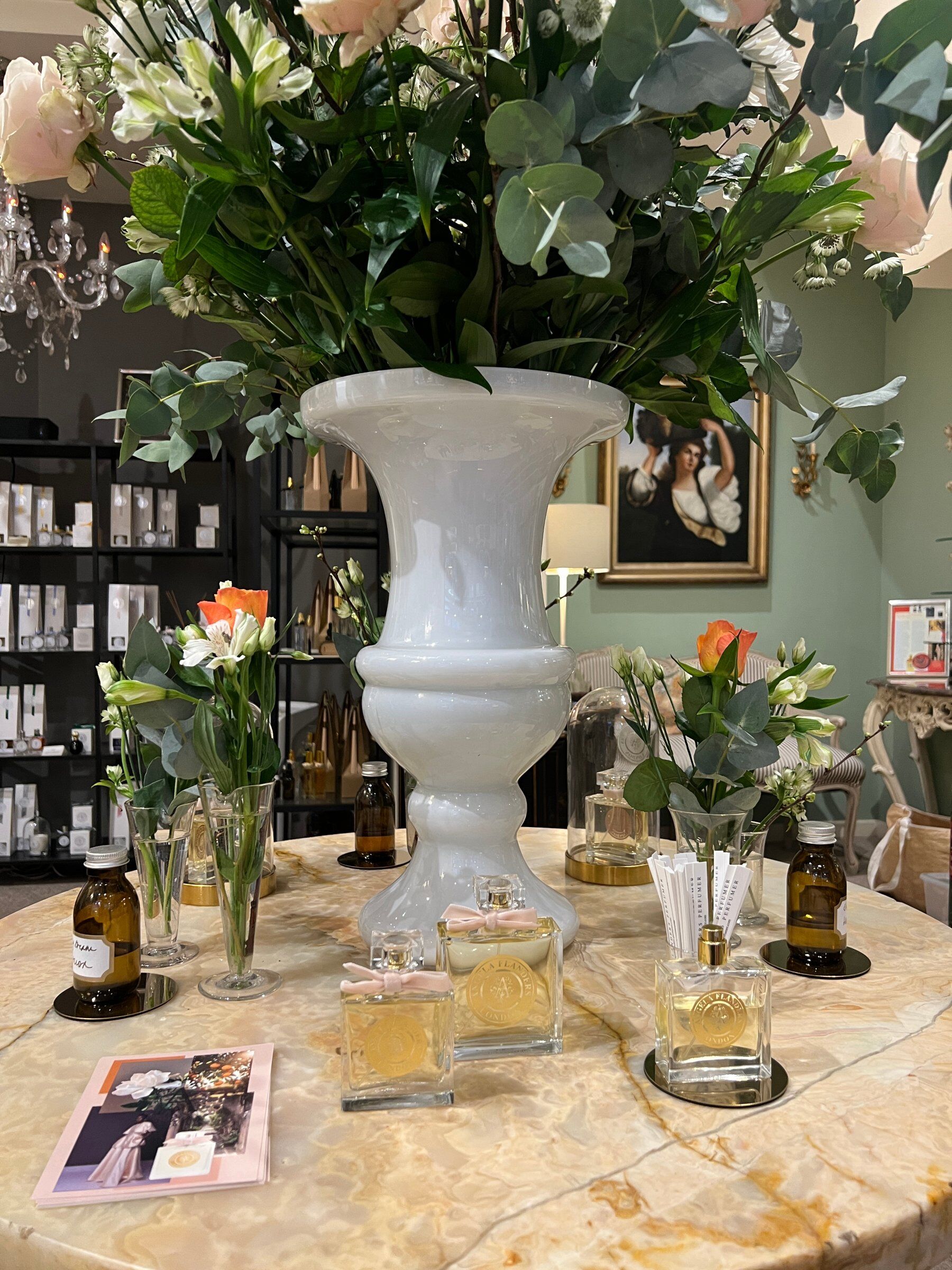 A photo of Shantung Dream on a table in the Angela Flanders store and underneath a big vase of flowers