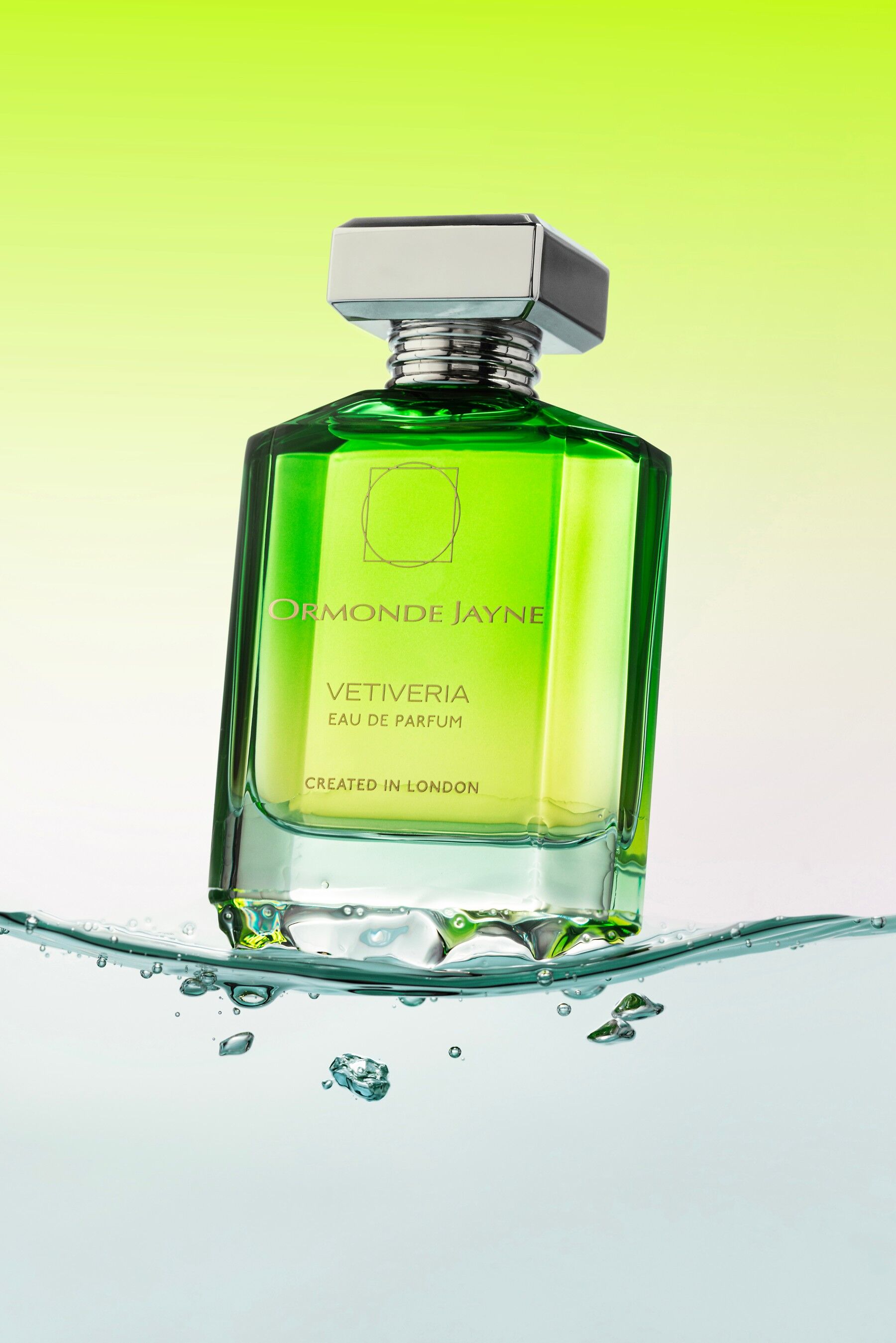 A bottle of Vetiveria by Ormonde Jayne on a wave of water with green behind
