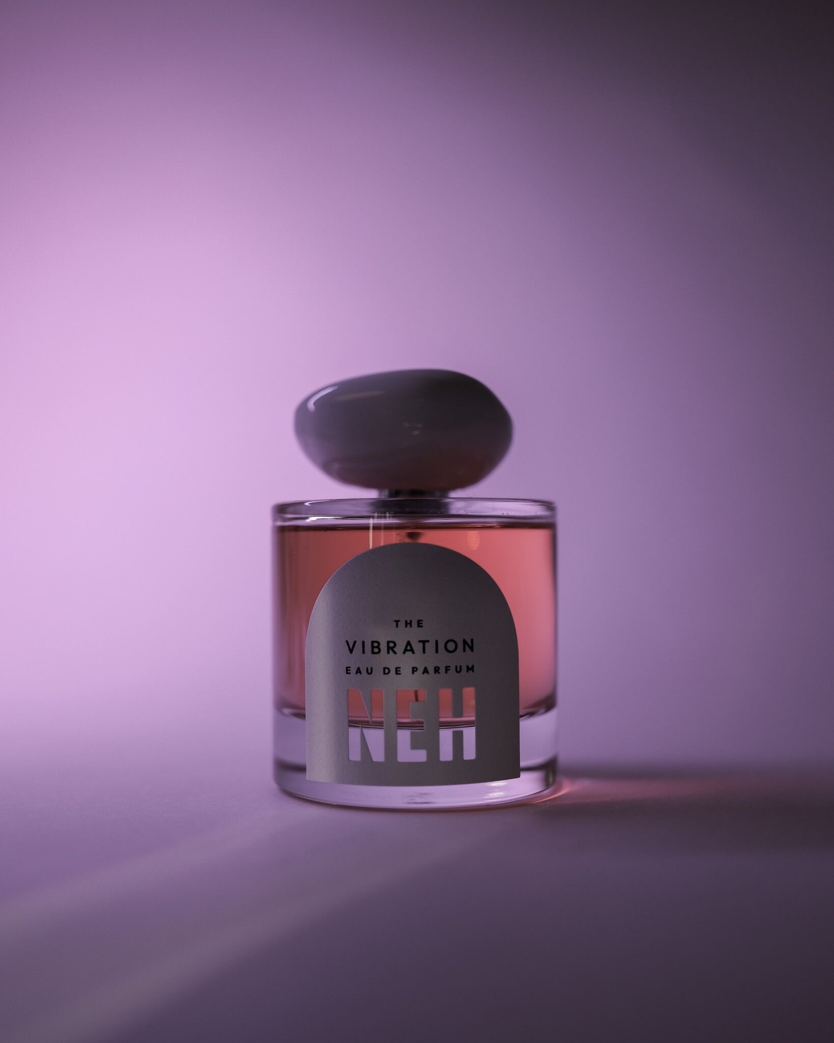 Perfume bottle on purple