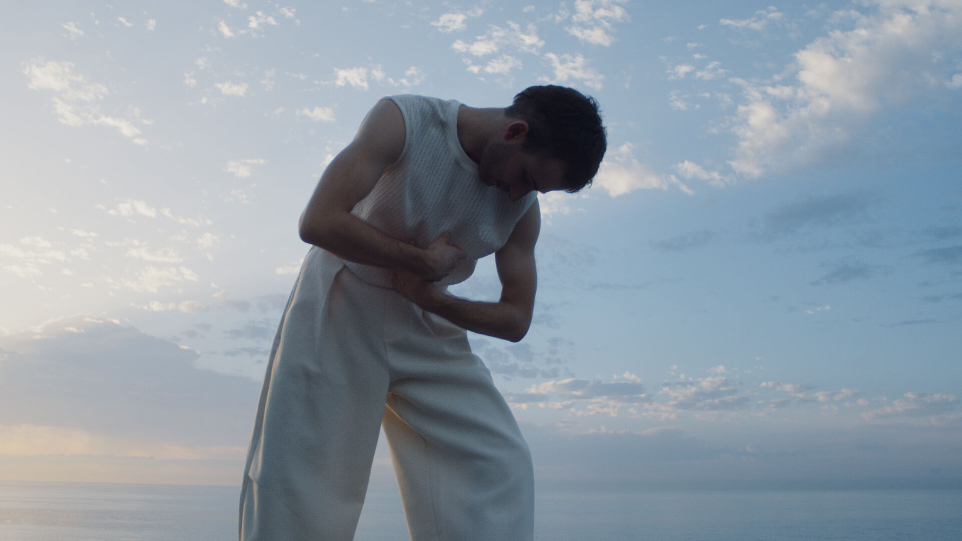 A man dancing against a blue sky