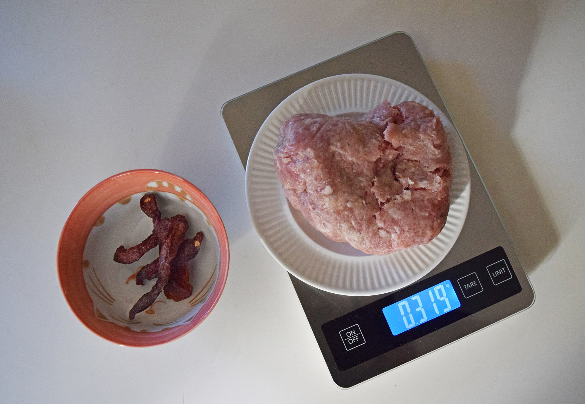 Ground pork on a scale for recipe.