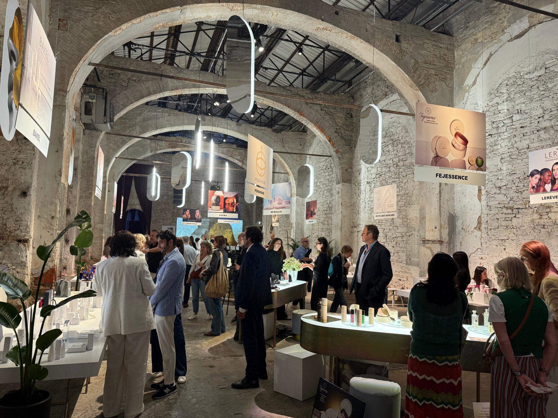 A side room at Pitti Fragranze showing people chatting