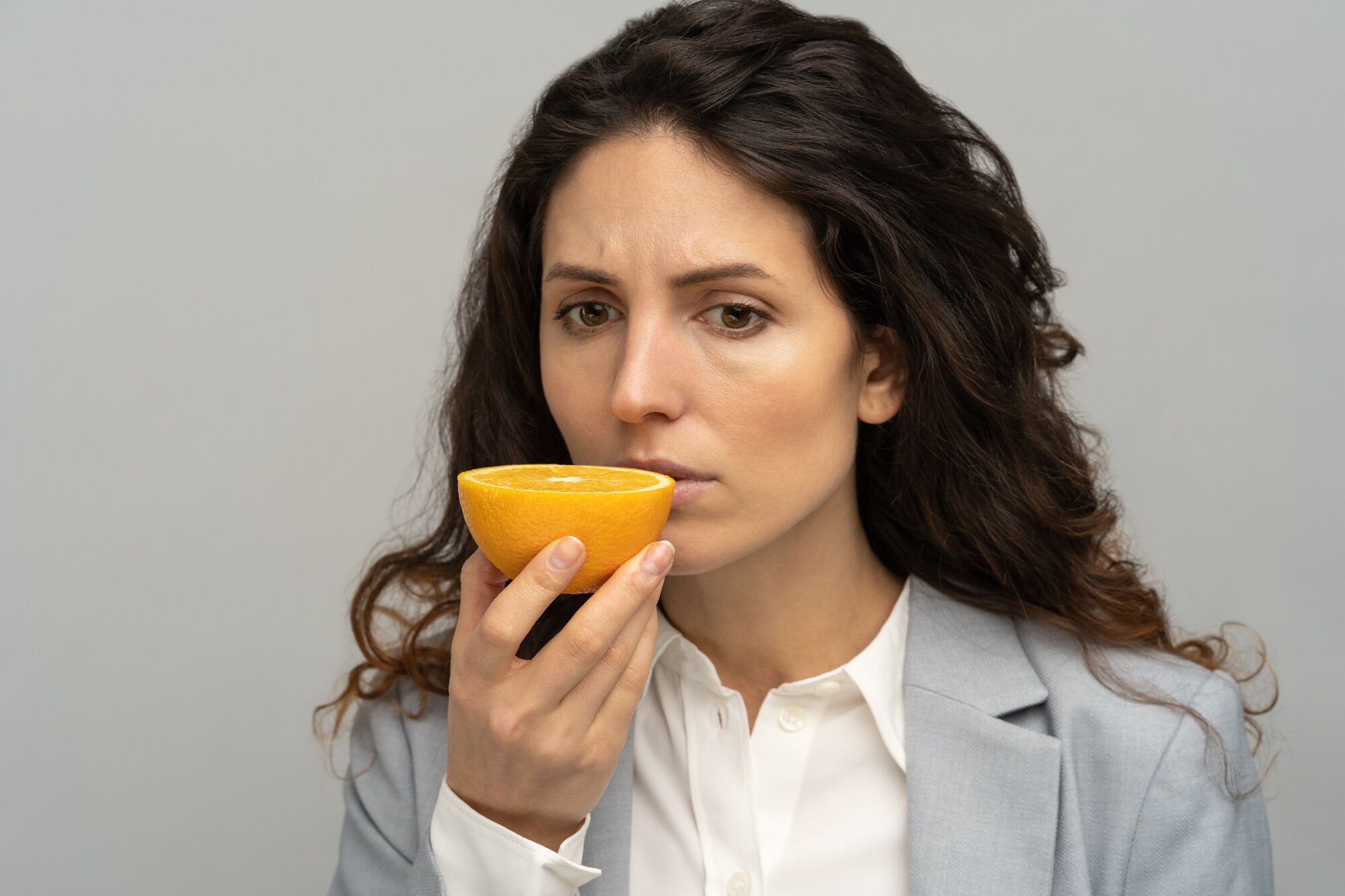 Woman smelling an orange