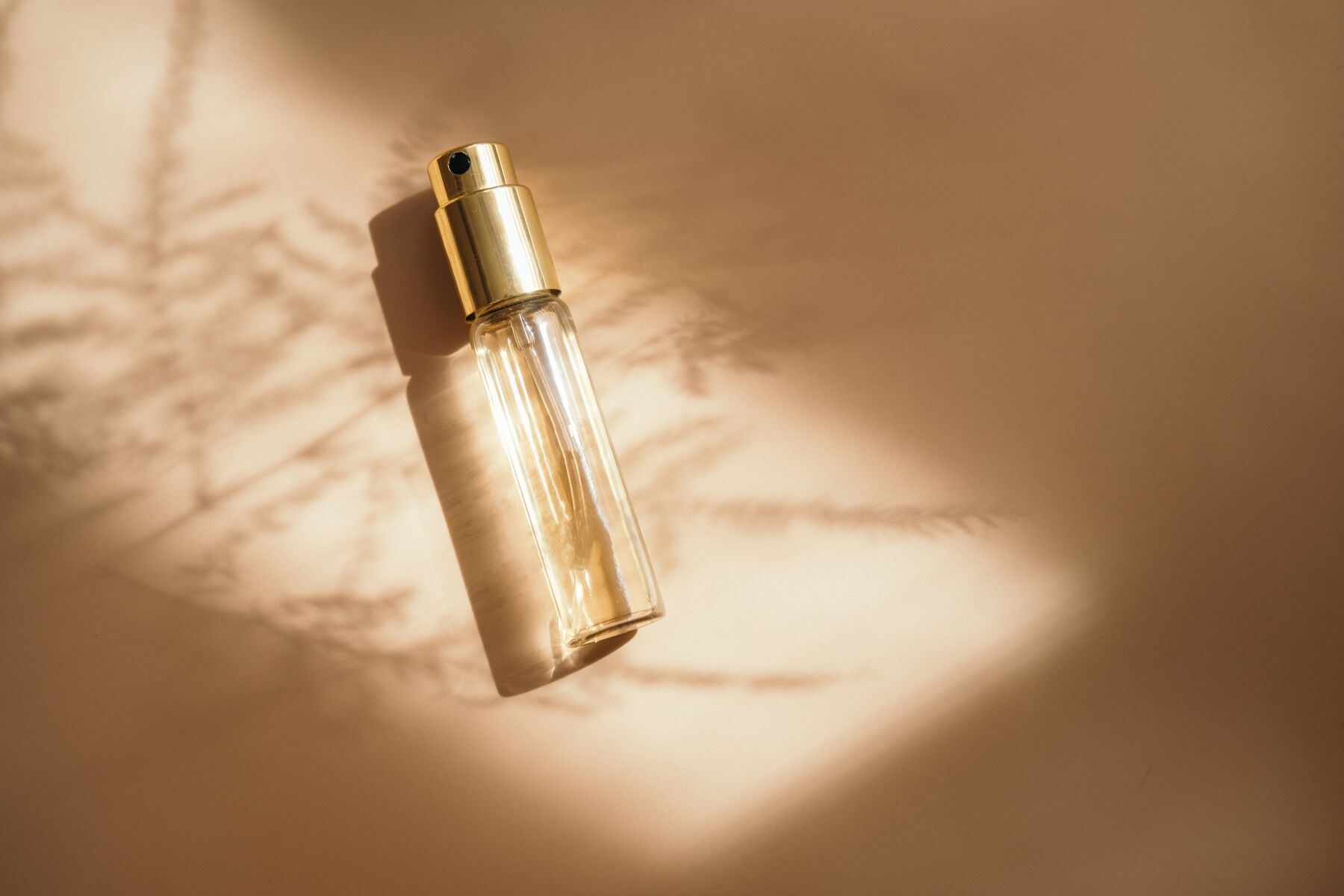 A small perfume bottle in dappled light