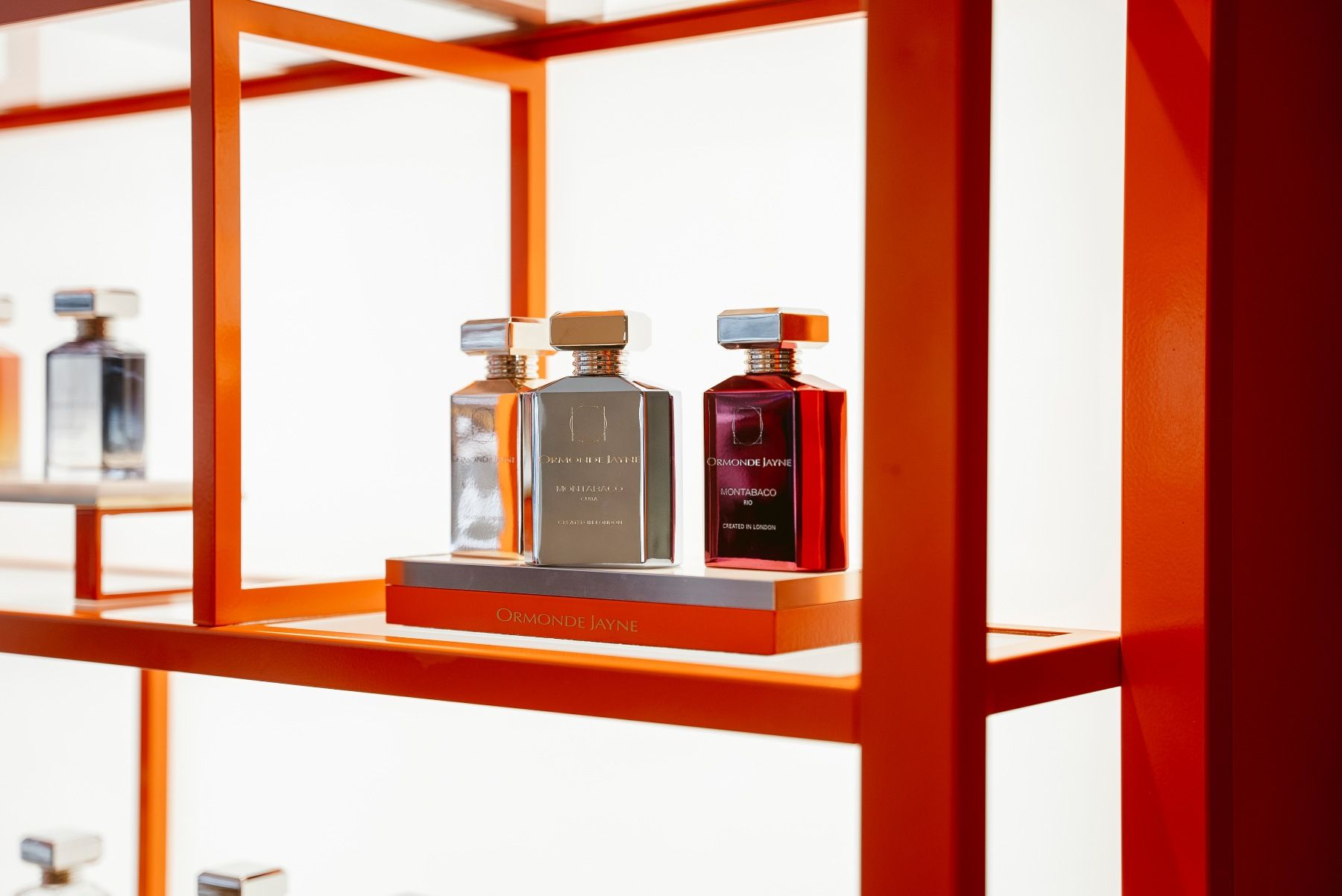 A group of Montabaco series bottles on orange shelves 