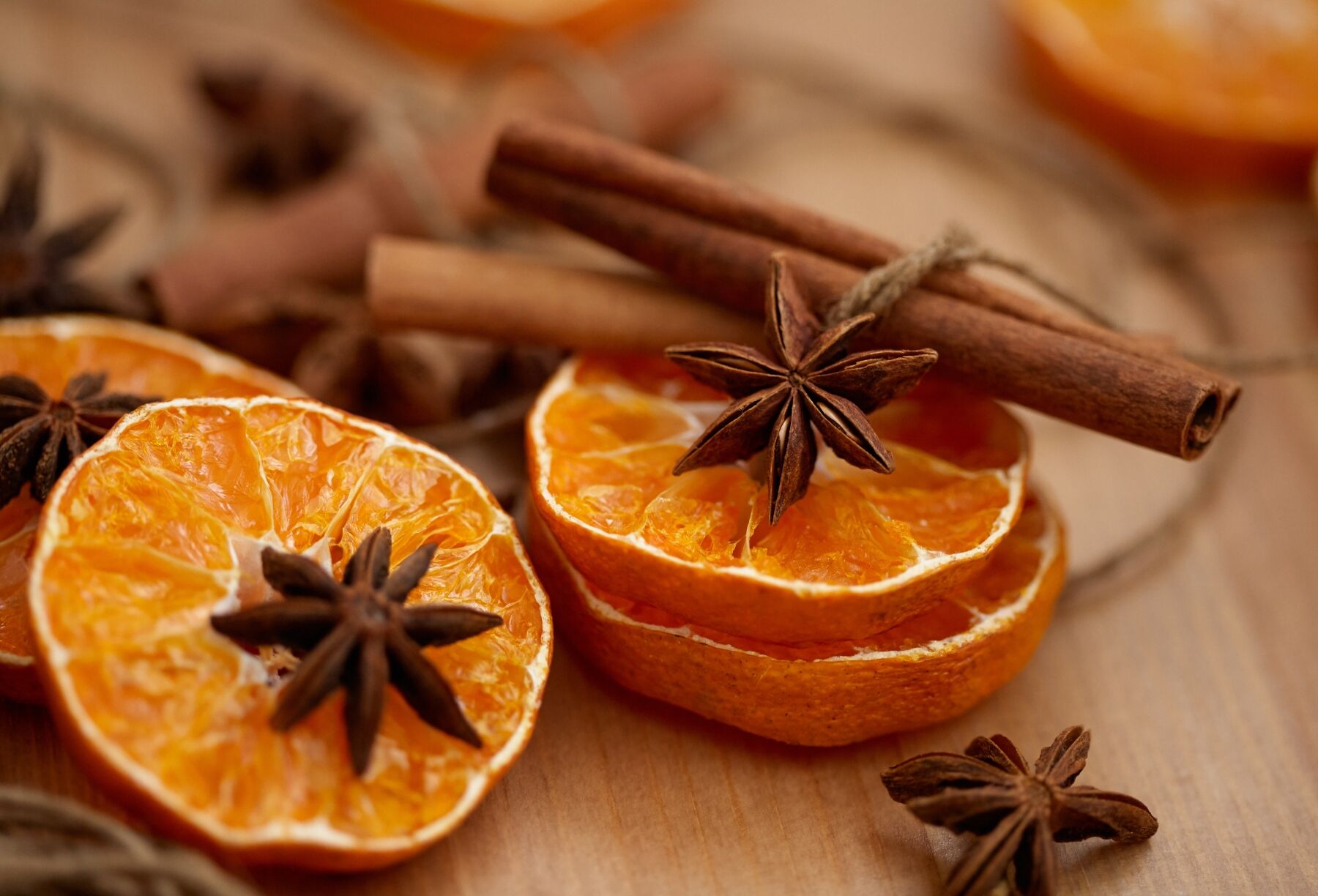 Slices of oranges and other citrus fruits with an array of spices
