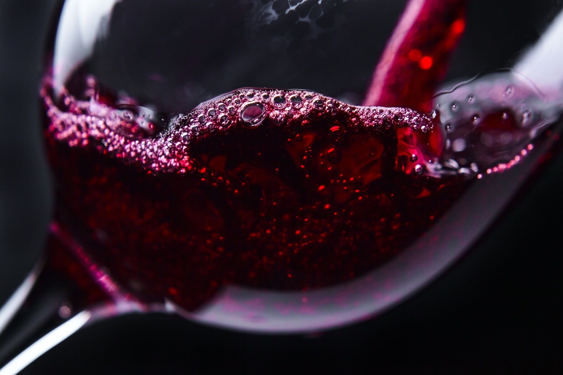 Red wine being poured into a glass